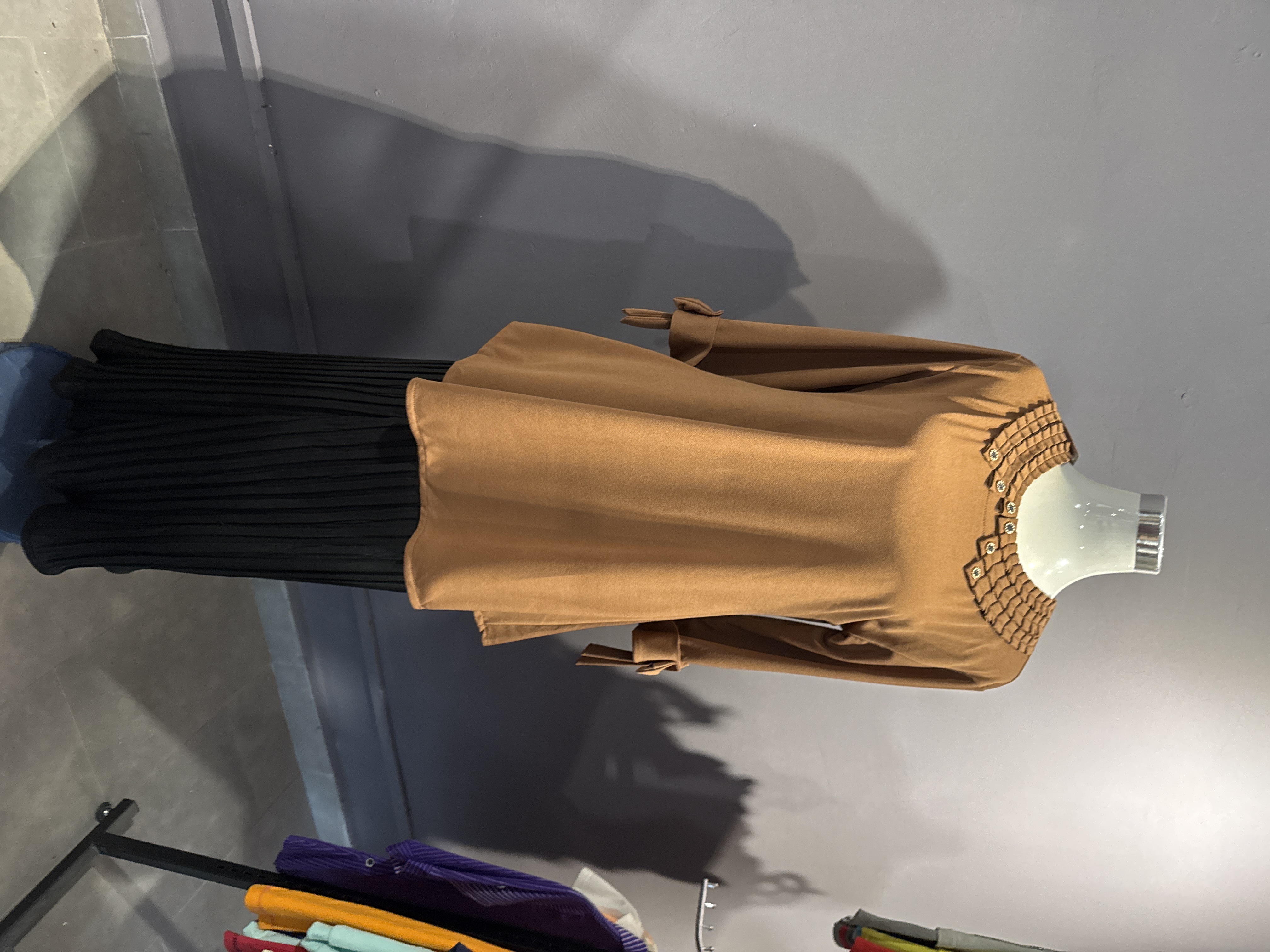 Malay-New style brown blouse and black skirts with a pleated collar